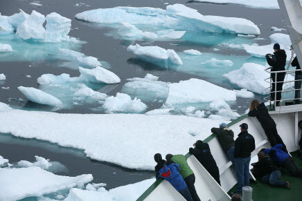 Students looking at sea-ice from a ship