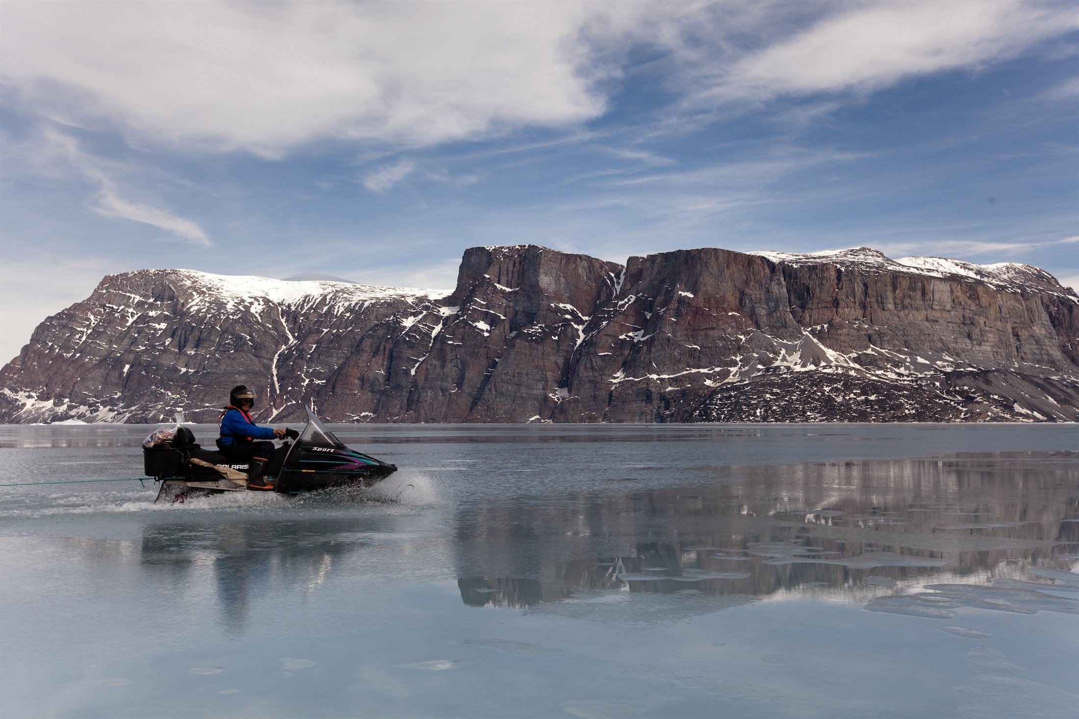 Snowmobile driving on open water